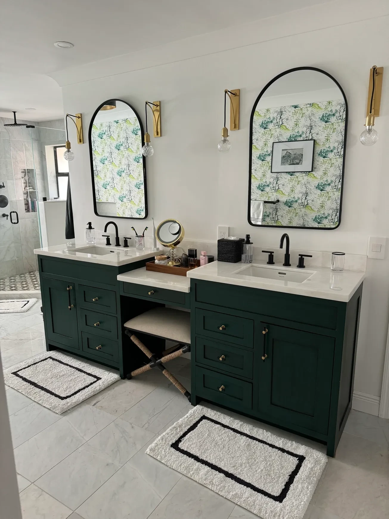 Bathroom with green double vanity and arched mirrors