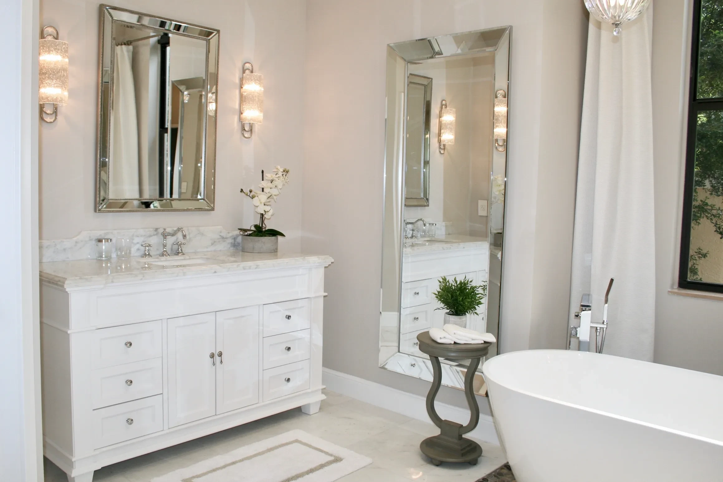 Bright bathroom with marble vanity and freestanding tub