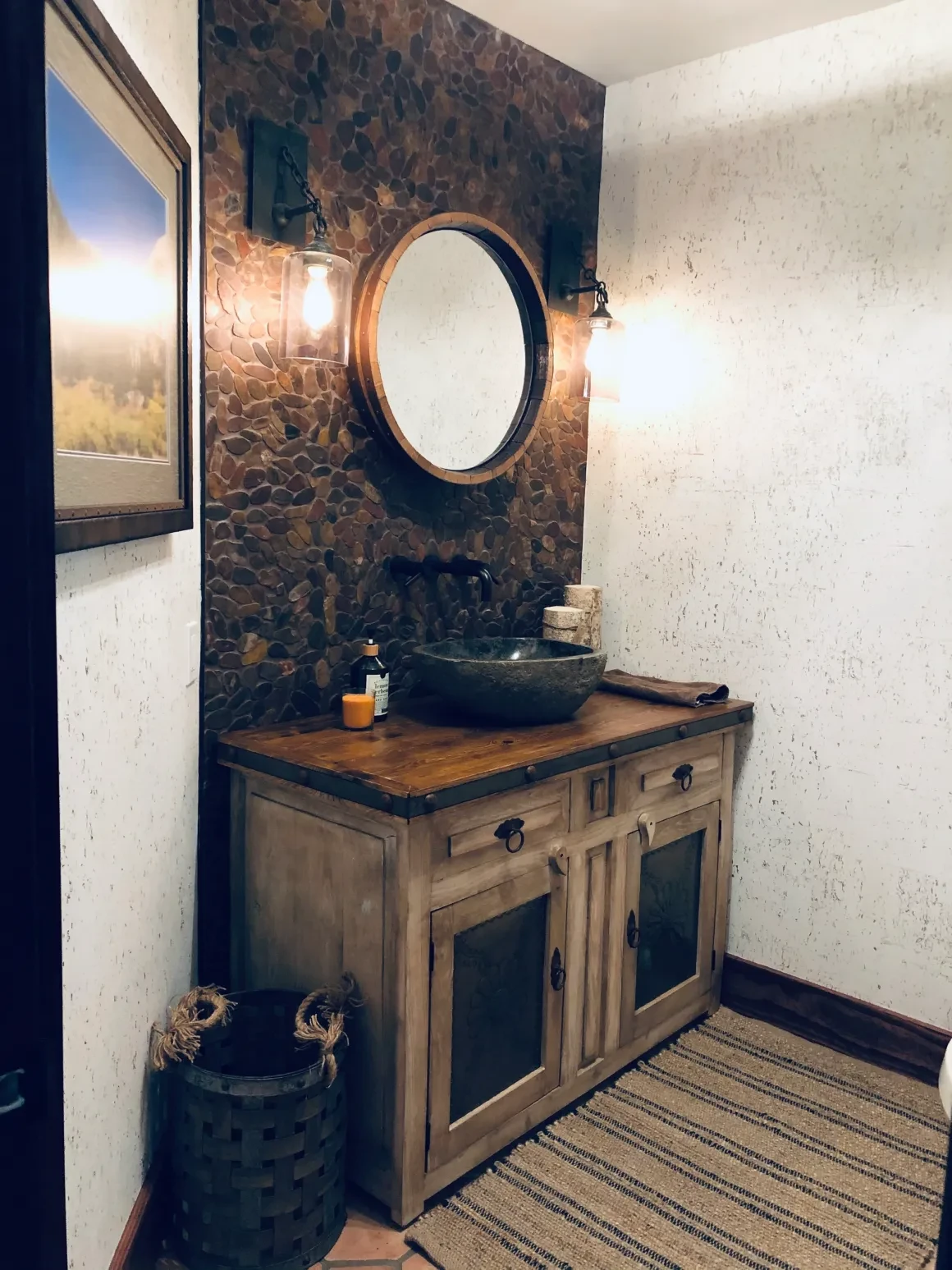 Rustic bathroom with wood vanity and stone accent wall